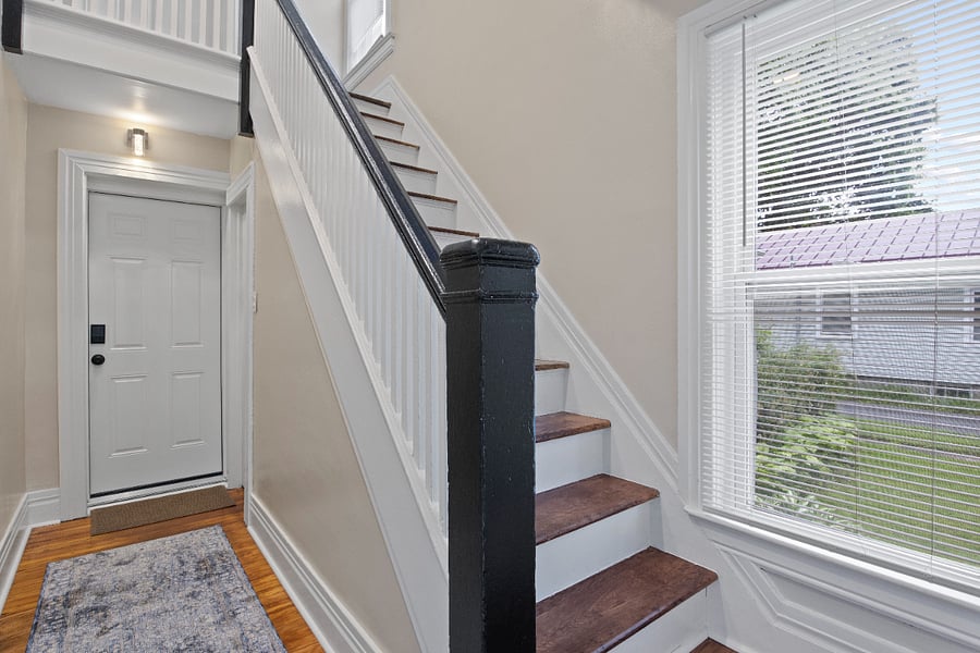 Main entrance view to stairs up to unit. 