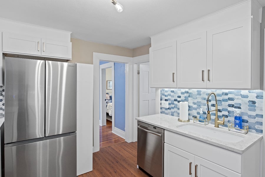 Kitchen view looking at full bedroom room.