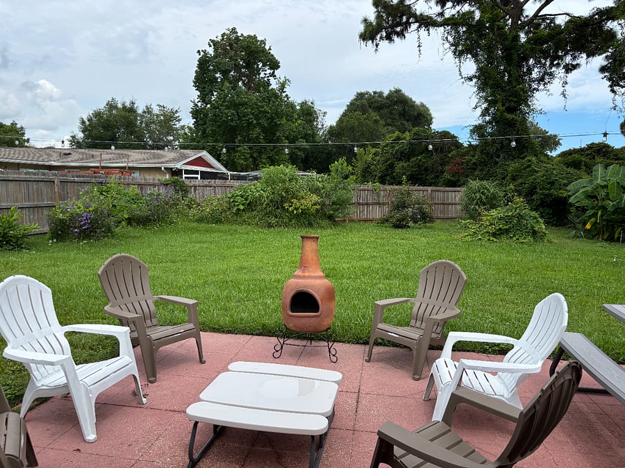 Twinkle lights, chimnea, 6 adorondak chairs and a picnic table for great outdoor relaxation space. Shaded in afternoon and evening