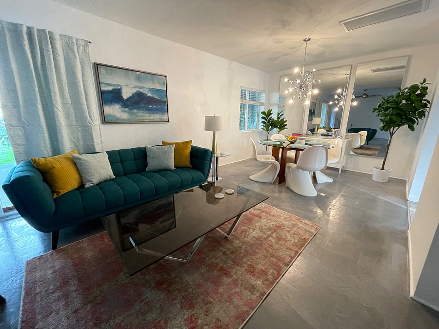 Brightly lit living room and dining area create a nice shared space to enjoy With views of the front yard and access to the front patio.