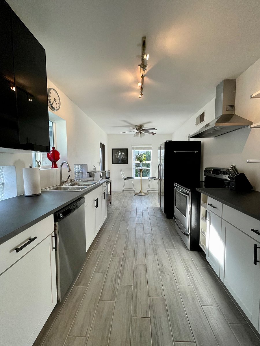 Fully stocked galley kitchen that offers views of the backyard and a door to access the fully gated backyard.