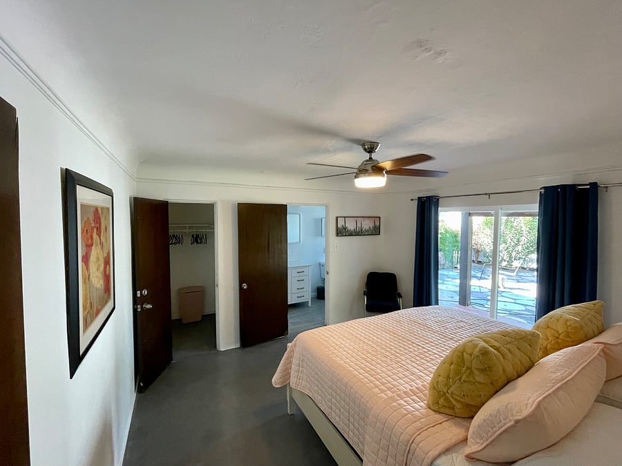 Large view of main bedroom, showing the walk-in closet and private bathroom.