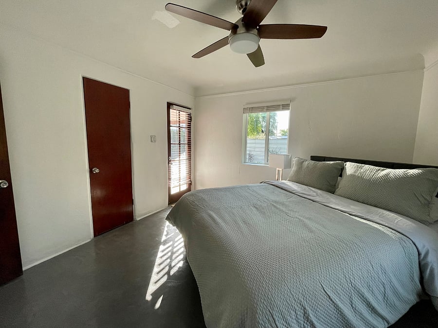 The back bedroom offers views of the fully gated backyard and a door to access the backyard. With a plush queen bed one will get a great nights sleep. Ample storage is provided with a walk-in closet and a large second closet. 