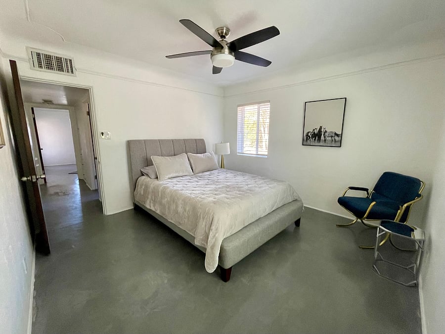 Third bedroom located at the front of house offers a plush queen bed, and a closet for storage. Beautiful, lighting and private.