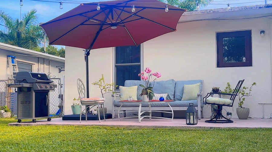 Backyard & Laundry room
The property includes a fully fenced grassy backyard quiet and private, with a back porch featuring outdoor seating and a cushioned sofa. Its a comfortable outdoor space for relaxing or enjoying a break in the day.