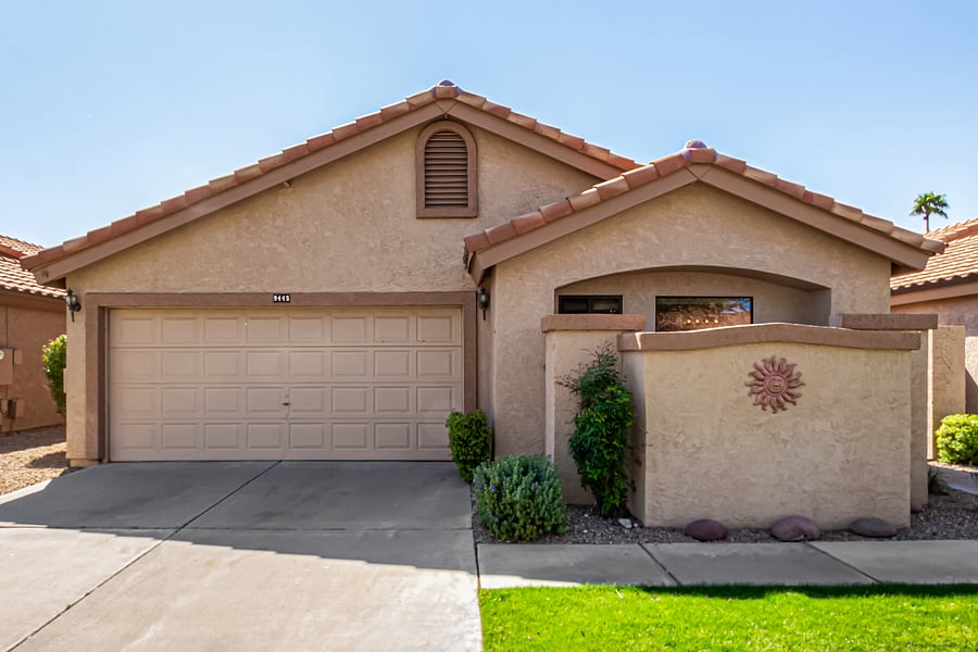 Outside view of front of house and garage from the street.