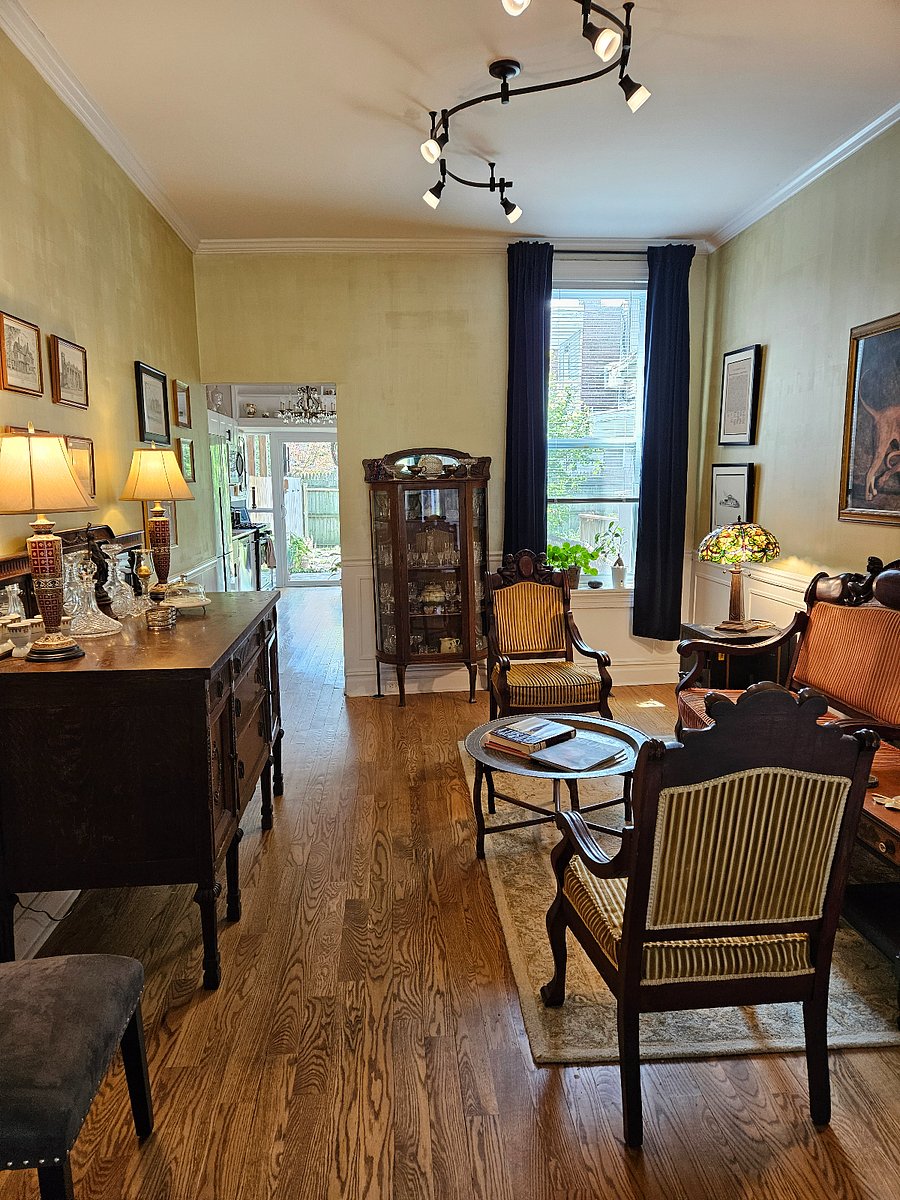 View of parlor & kitchen on main level.  NOT the most comfortable seating out there, but perfect for entertaining guests or work associates for quick exchanges.