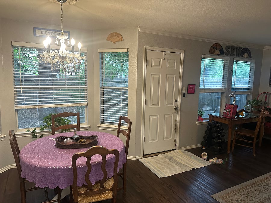 Cozy breakfast nook and full wall of windows with a view into the shady back yard.