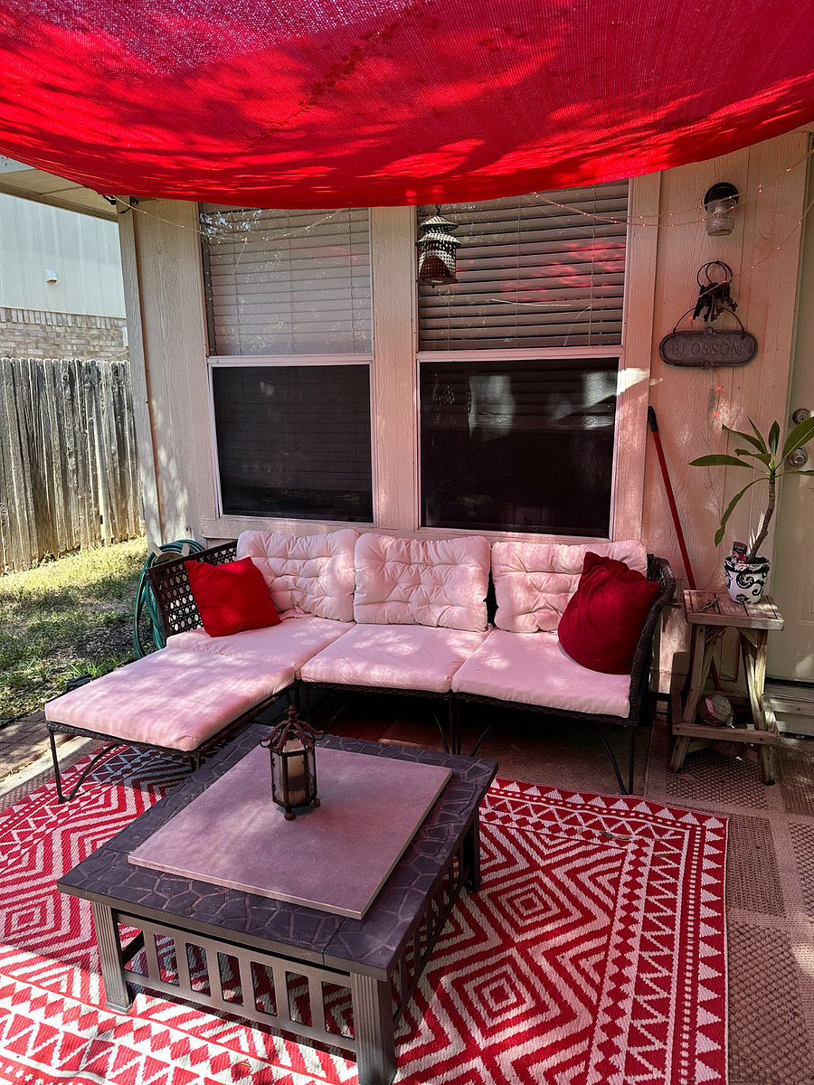 Cozy backyard retreat includes a seating area, fire pit, sunshade and great view.