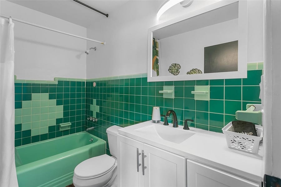 Bathroom in Hall near Kitchen serves public living spaces and also the 3rd bedroom.