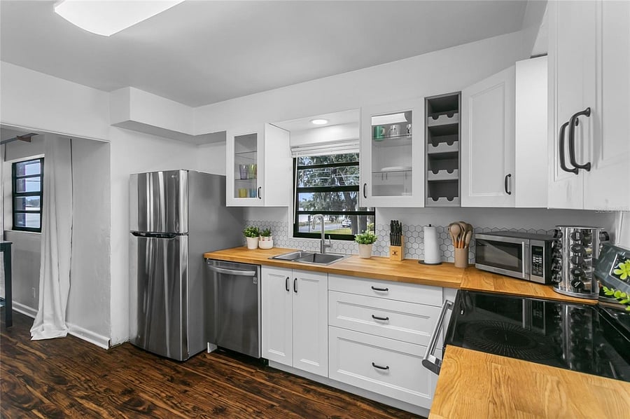 Kitchen with stainless steel dishwasher and fridge