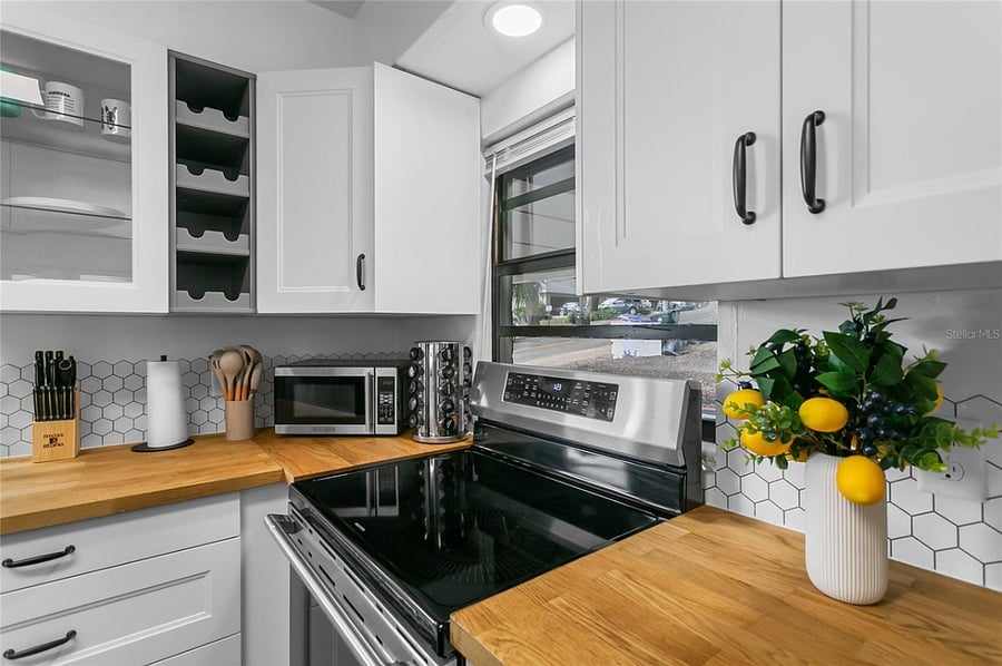 Kitchen with induction stove and upper cabinet storage