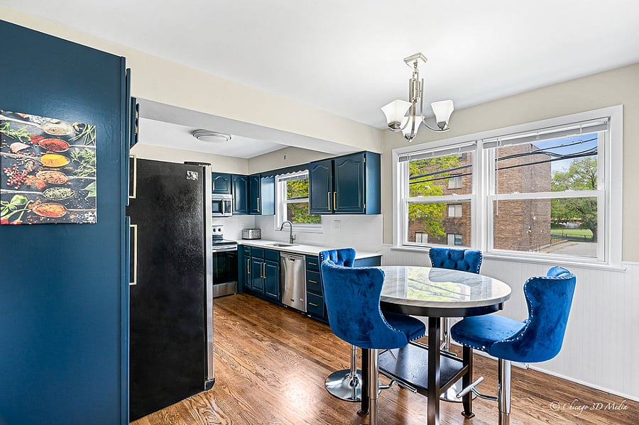 Stunning breakfast area with counter height marble table and rich blue velvet stools.