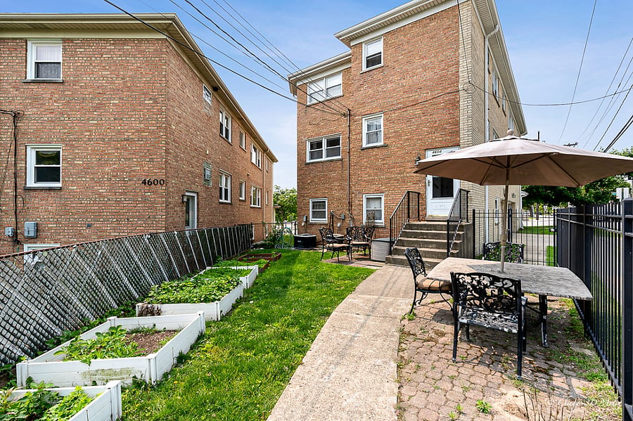 Private fenced-in backyard with garden boxes perfect for relaxing or planting