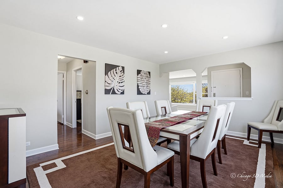 Solid wood contemporary dining table with gorgeous "keyhole" dining chairs and matching bar all set a top of a brand new perfectly coordinating over-sized 100% wool hand tufted brown and cream area rug.