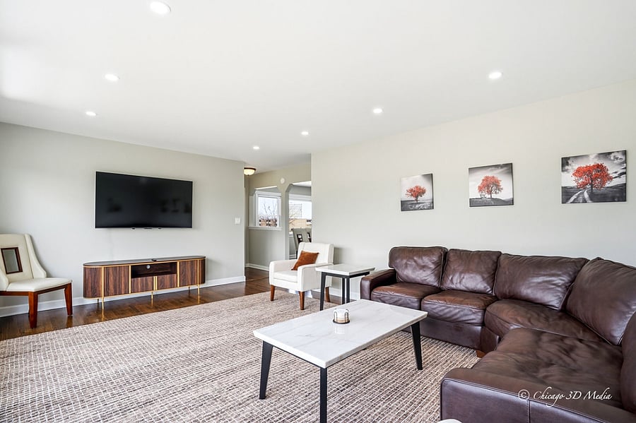 Rich brown luxurious 100% premium leather Toms Price Home sectional couch with real marble coffee and end tables.