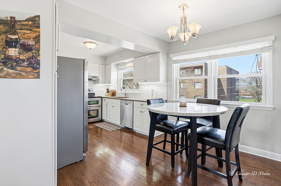 Dedicated breakfast area with counter-height genuine marble table and leather stools.