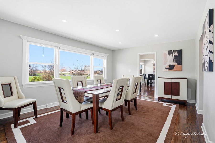 Spacious dining room with abundant natural lighting.