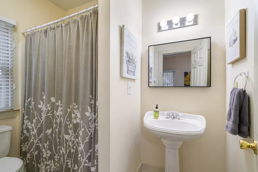 En-suite full bathroom with bath/shower combo, located off master bedroom.