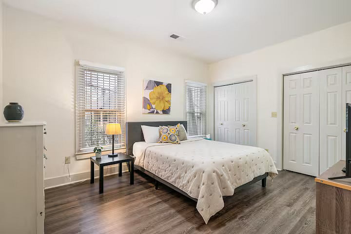 Master bedroom with comfy queen bed, two spacious closets, en-suite full bathroom, and smart TV.