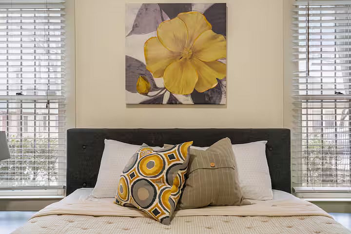 Master bedroom with comfy queen bed, two spacious closets, en-suite full bathroom, and smart TV.