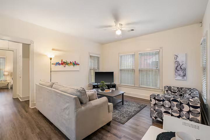 Cozy living room with comfy seating and smart TV.