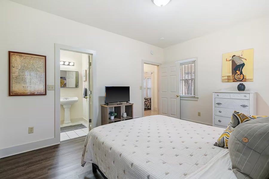 Master bedroom with comfy queen bed, two spacious closets, en-suite full bathroom, and smart TV.