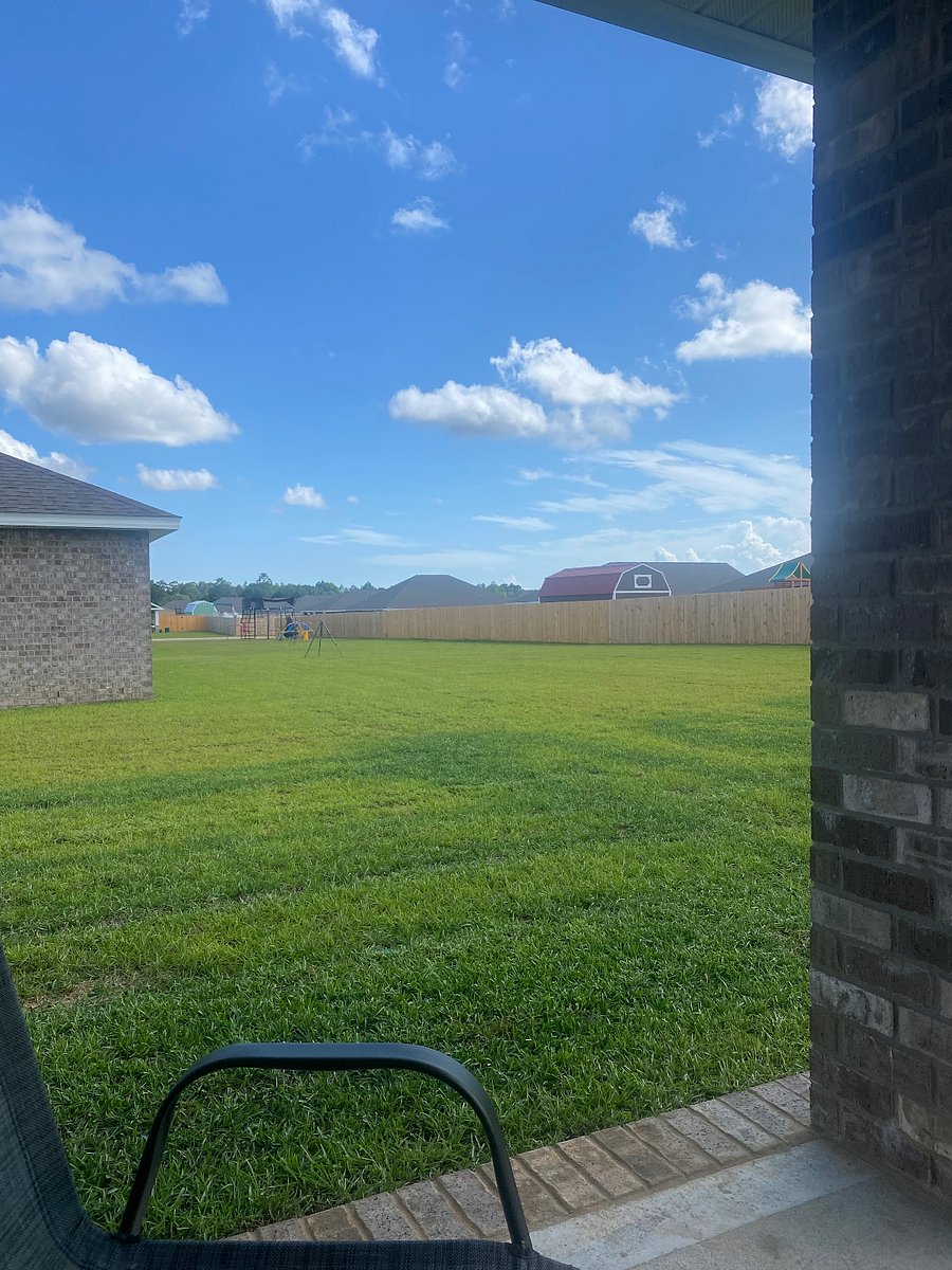 View to left of house, neighbors back yards.