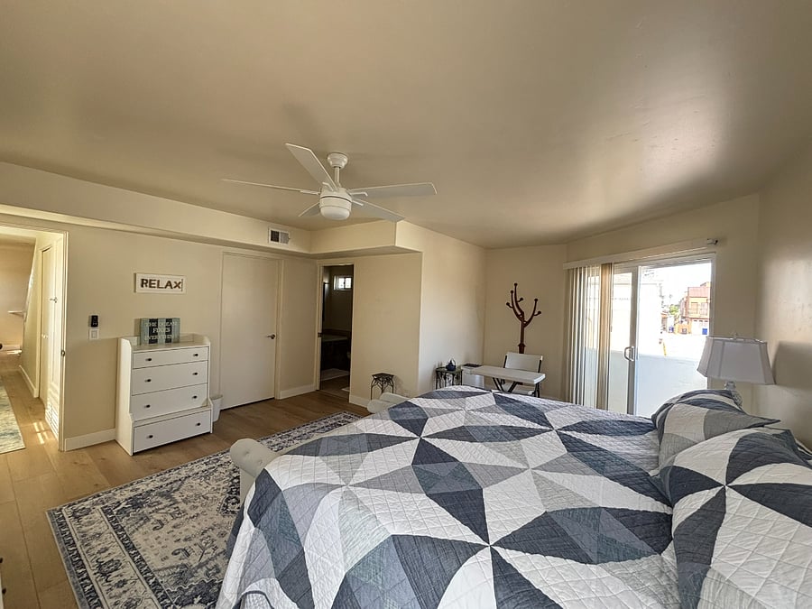 primary bedroom with a balcony and extra large walk in closet. King sized bed
