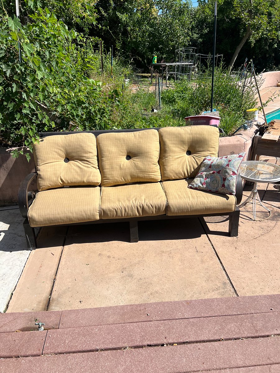 This is the patio with an outdoor couch and table. 