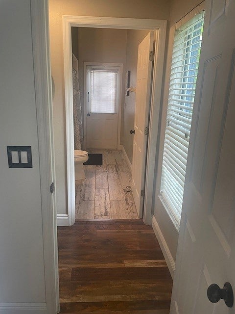 View from bedroom door to hallway and large bath with walk-in shower on the left. 
