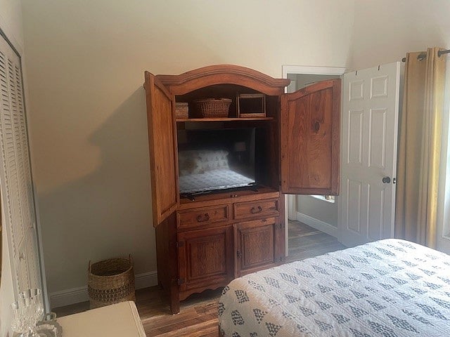 TV cabinet with a mini fridge in bottom area and drawers for storage.