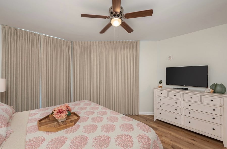 The primary suite is also equipped with a full size dresser & two nightstands. There is also a large primary closet with a full size ironing board, iron, hangers, and extra bedding if needed