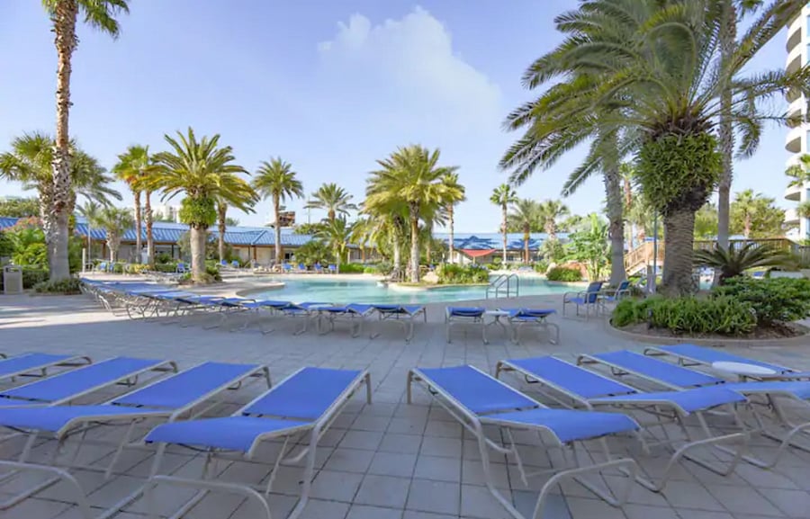 Tons of loungers available poolside with a gorgeous view of the resort & palm trees