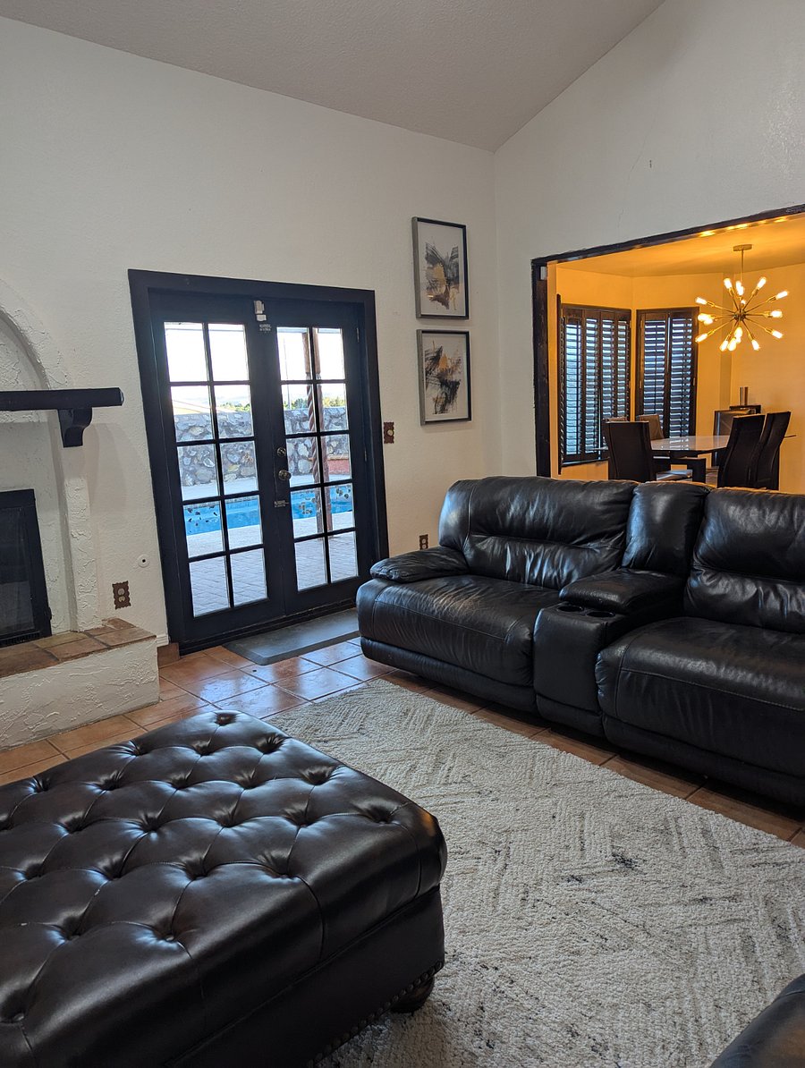 Cozy fireplace and natural lighting with views of the pool