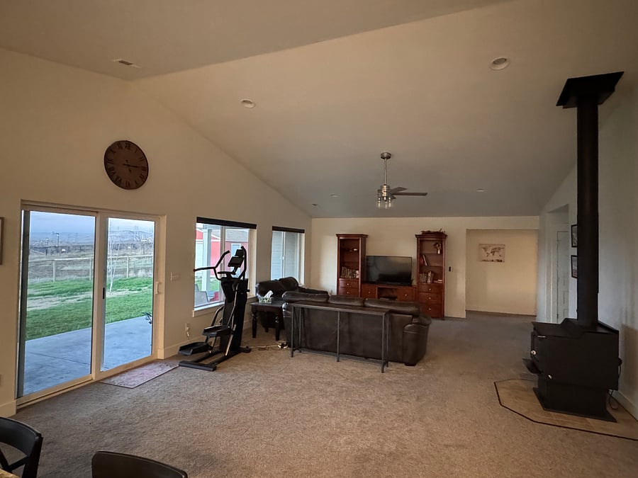 Living room with TV, seating and exercise equipment 
