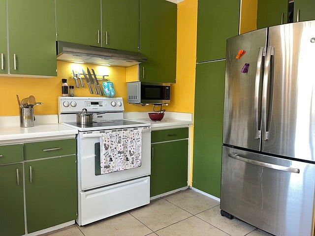 This is the kitchen area that has full size refrigerator, dishwasher, electric range, microwave, toaster and coffee maker.