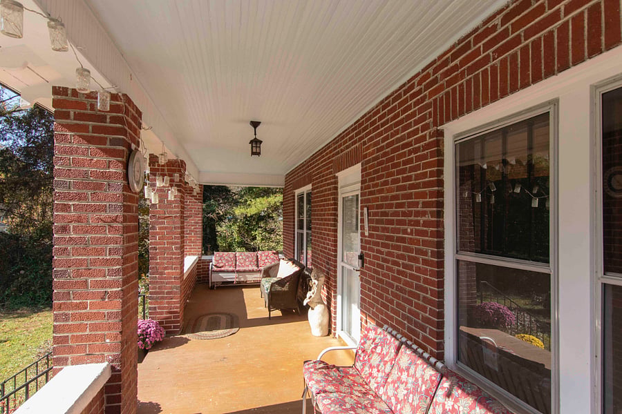 The front porch is a favorite place to relax with a glider and plenty of seating to enjoy a country sunset