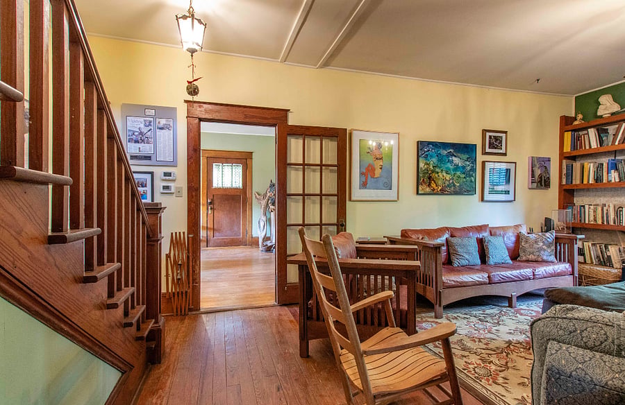 This is the large den and doorway to living room and front entrance. The beautiful stairway leads to heavenly comfortable rooms
