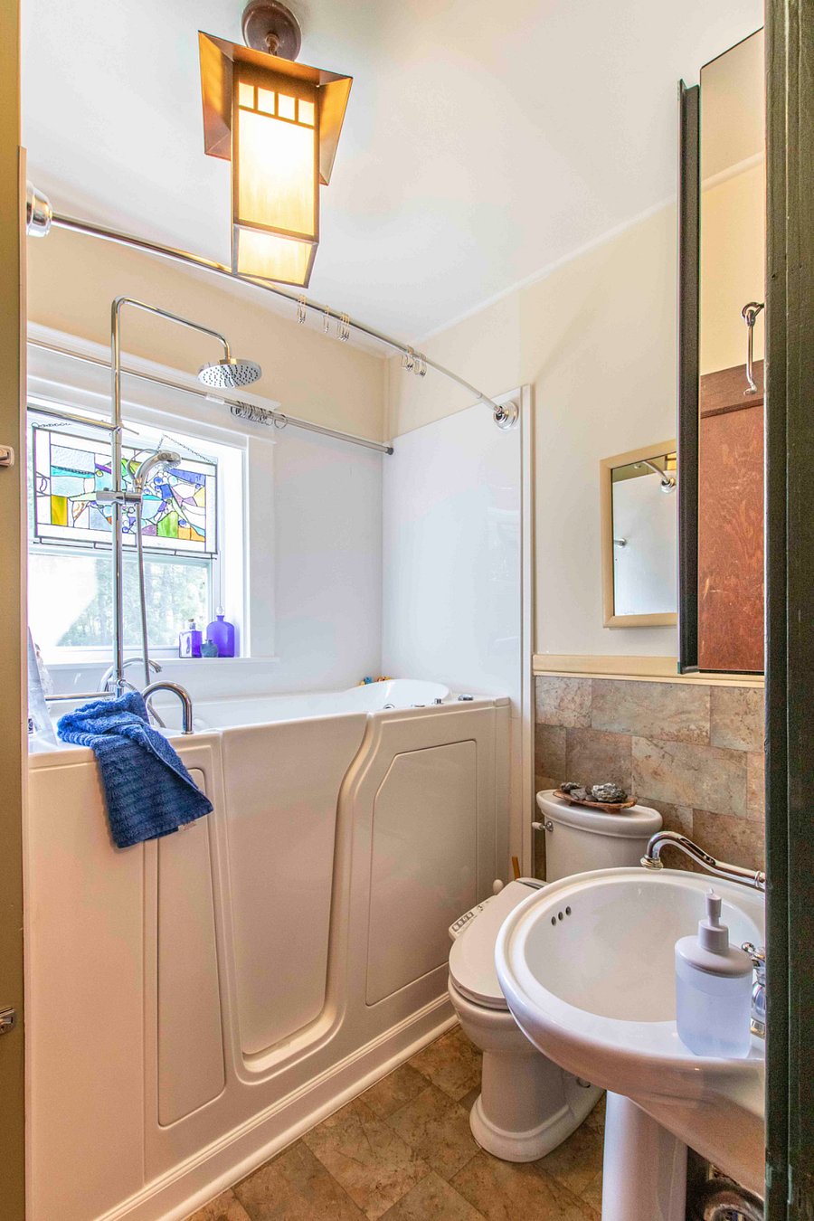 This walk in tub has lots of bubble jets and a rain shower. There is also a bidet.