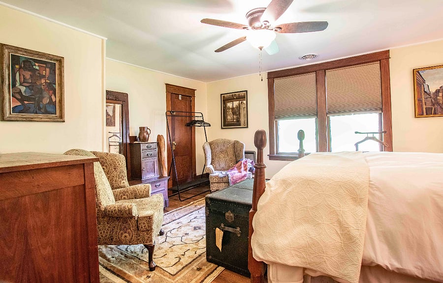 This upstairs bedroom also has blackout shades and two comfortable wingback chairs