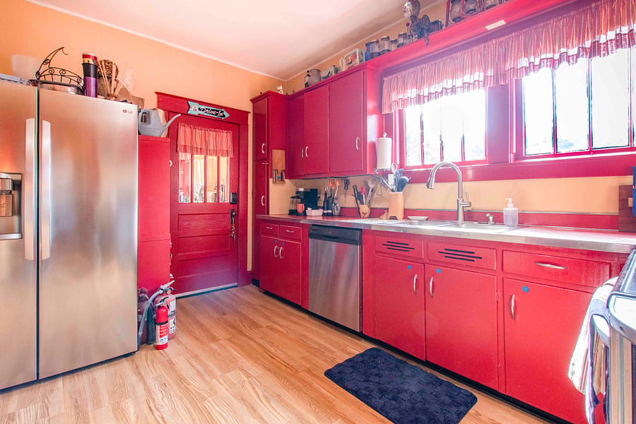 A Roomy country kitchen with door to a laundry porch and the back door