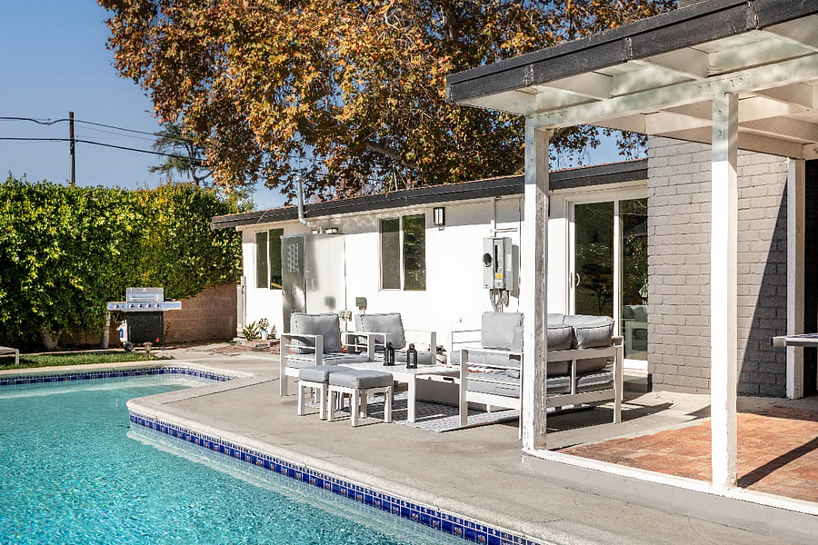 Covered patio with outdoor dining and pool access