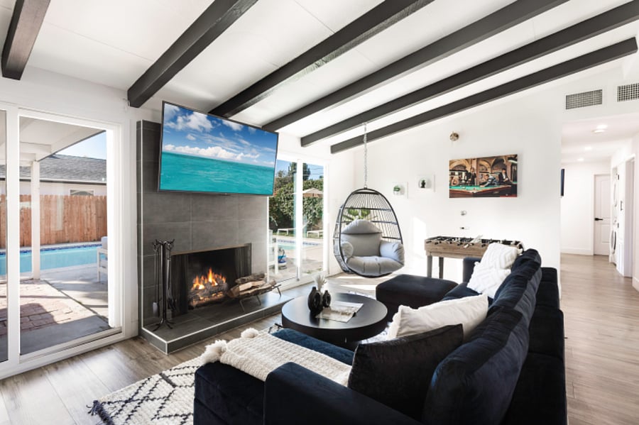 Modern living room with smart TV, fireplace, and comfortable seating
