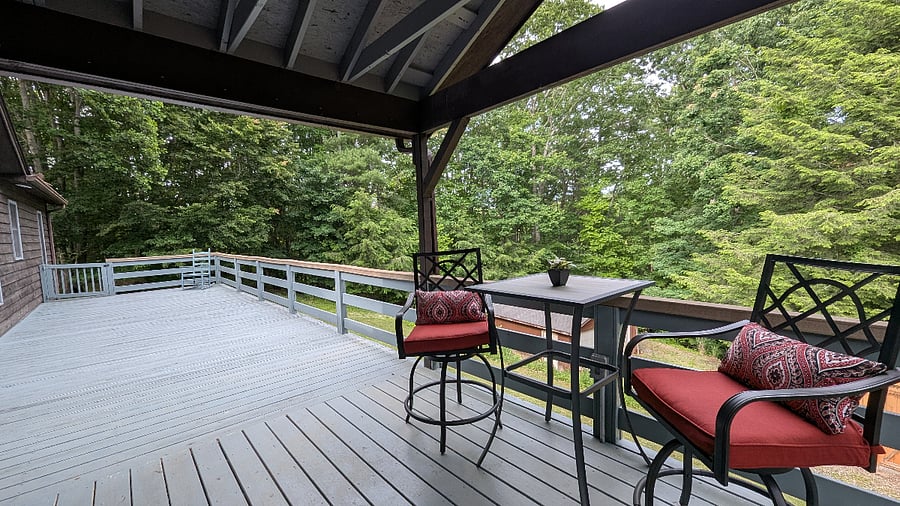 Unwind on the spacious 12x44 deck overlooking a peaceful wooded landscape the perfect spot for coffee, reading, or evening relaxation.