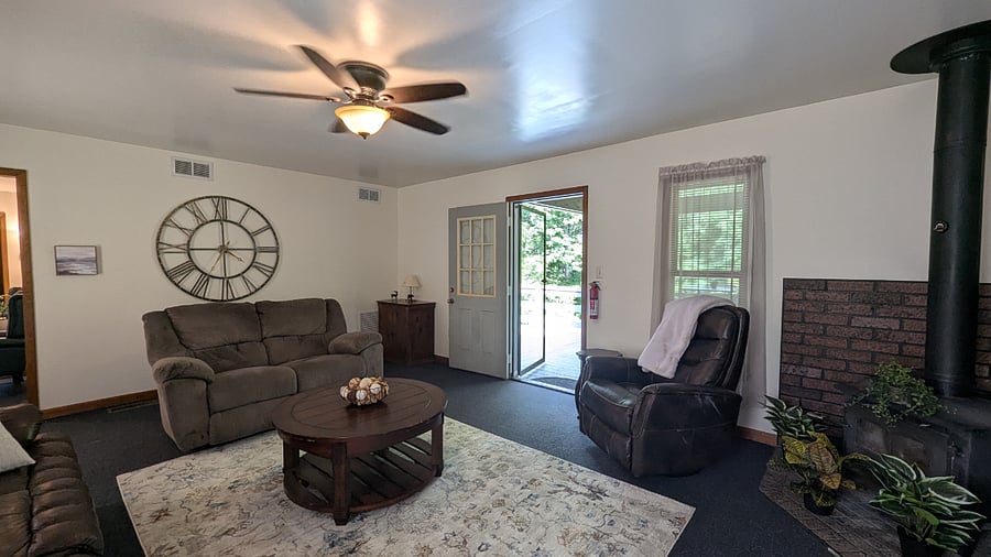 Kick back in the inviting living room featuring a comfortable sitting area, plush seating, and a large smart TV ideal for streaming after a long day. This space is perfect for both unwinding and entertaining.