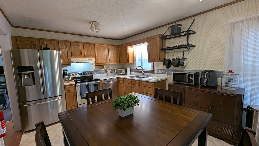 This modern kitchen features sleek stainless steel appliances, a full-size dishwasher, and everything you need to feel right at home including a Ninja air fryer, toaster oven, coffee maker, and grinder. Whether you're prepping quick meals or brewing the perfect cup, this space is built for convenience and comfort