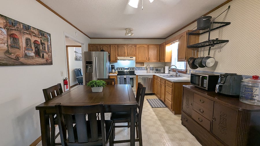 Enjoy an open-concept kitchen and living space with modern appliances, ideal for cooking, relaxing, or hosting a quiet dinner.