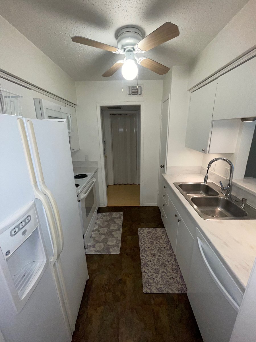 Kitchen entry from dining room. Overhead fan.