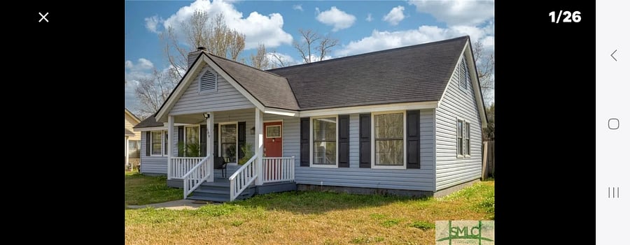 Front of house with front porch seating.